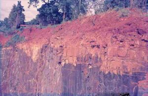 Effects of Weathering: Reddish Coloration in Lateritic Soils and Rocks Indicates Mineral Alteration and Chemical Weathering (Credit: Werner Schellmann 1970 .CC BY-SA 2.5.)